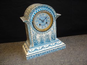 A late 19th Century blue and white ceramic mantle clock in the Arts & Crafts manner