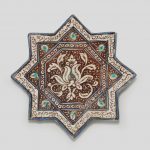 A Kashan lustre pottery star tile Persia 13th/ 14th Century