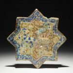 An Islamic luster glaze relief-decorated star tile