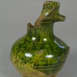 Earthenware drinking jug, buff and green-glazed