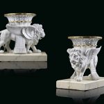 TWO SEVRES WHITE BISCUIT PORCELAIN MODELS OF LIONS SUPPORTING BASKETS (LIONS 'CORBEILLES' OR 'CANEPHORES' )